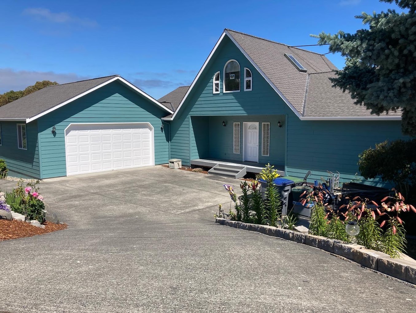 Large Blue home with attatched garage, Sequim exterior paint job in Dragonfly blue, 2022.